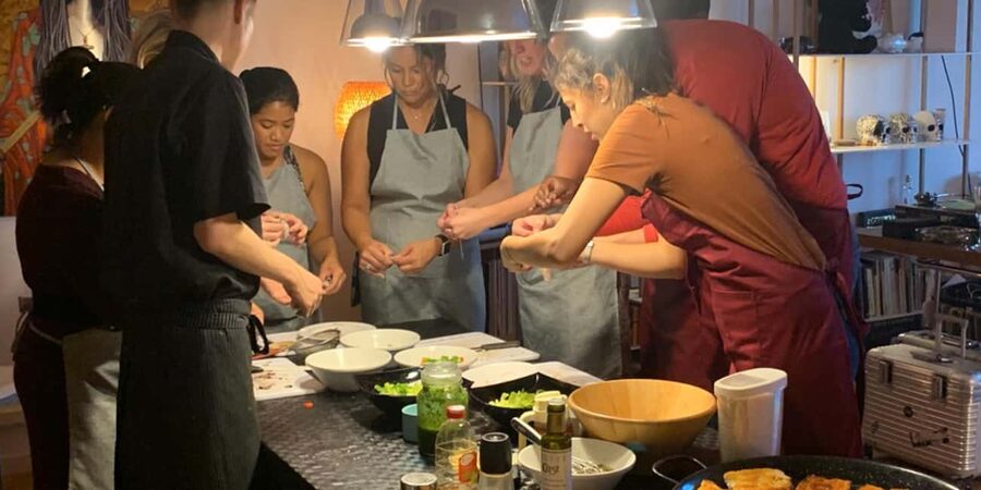 Barcelona Authentic Paella and Sangria Cooking Class - Eating pan tomaquet, salad, and Catalan cream