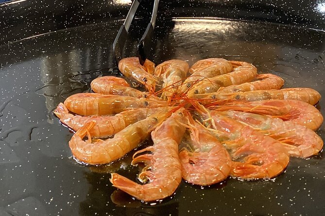 Barcelona: Black Ink Seafood Paella Cooking Class - Cooking with Maria and sharing the work