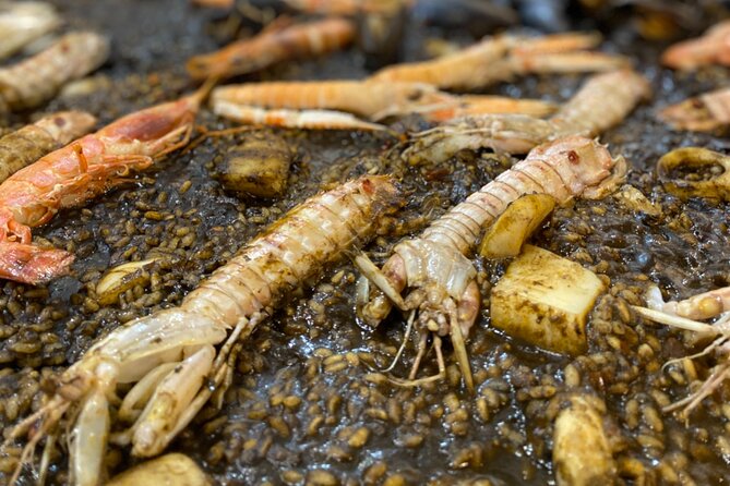 Barcelona: Black Ink Seafood Paella Cooking Class - The candlelit table and final meal