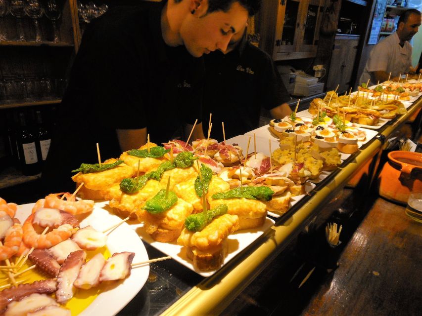 Barcelona: Evening Walking Tour in the Gaudi Area with Tapas - The historic bodega and Catalan flavors