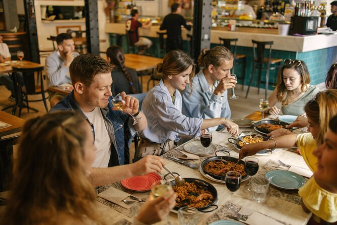 Barcelona: Guided Food Walking Tour with Tapas and Wine - Walking past Roman walls toward El Born