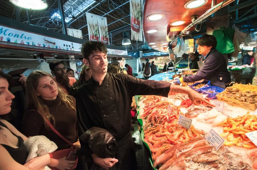 Barcelona: Paella Cooking Experience & Boqueria Market Tour - Learning paella beside the large pan