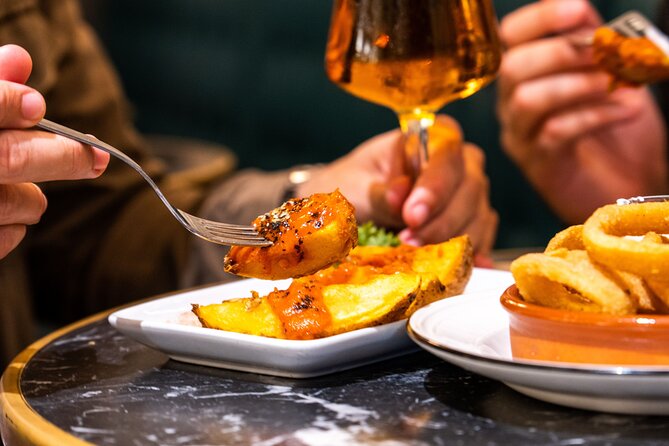 Gourmet Tapas and Wine Tour in Palma de Mallorca - Walking Carrer del Sindicat between bites