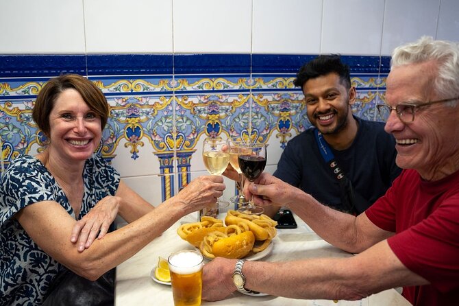 A tiled bar counter in Spain, plates of pintxos and a glass of vermouth