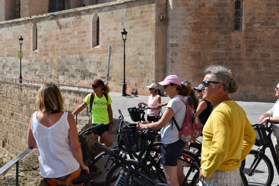 Palma de Mallorca: Guided Bicycle Tour with Tapas & a Drink - Reaching La Lonja and the final neighborhoods