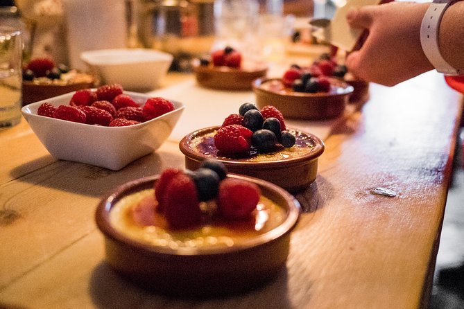 Premium Paella Cooking Class & 10 Spanish Tapas - Cooking seafood paella in small teams