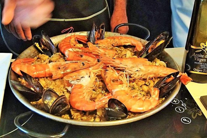Premium Paella Cooking Class & 10 Spanish Tapas - The instructors shape the mood