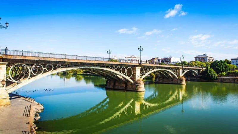 Seville: Tasting, History, Market visit and Tapas Tour - Crossing the Triana Bridge to the market