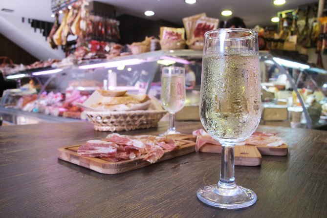 Taste of Malaga Tour : Tapas, History and Local Customs - Iberian ham and vermouth at a traditional grocery shop
