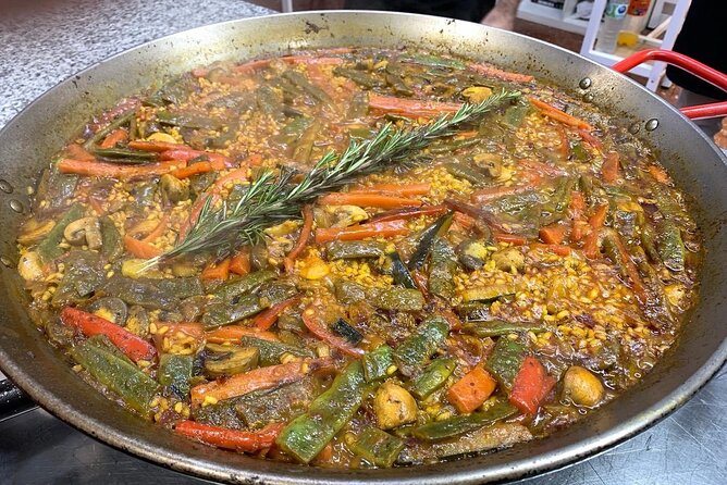Vegetable Paella cooking class, tapas and Ruzafa market visit - Sitting down to a full Valencian meal